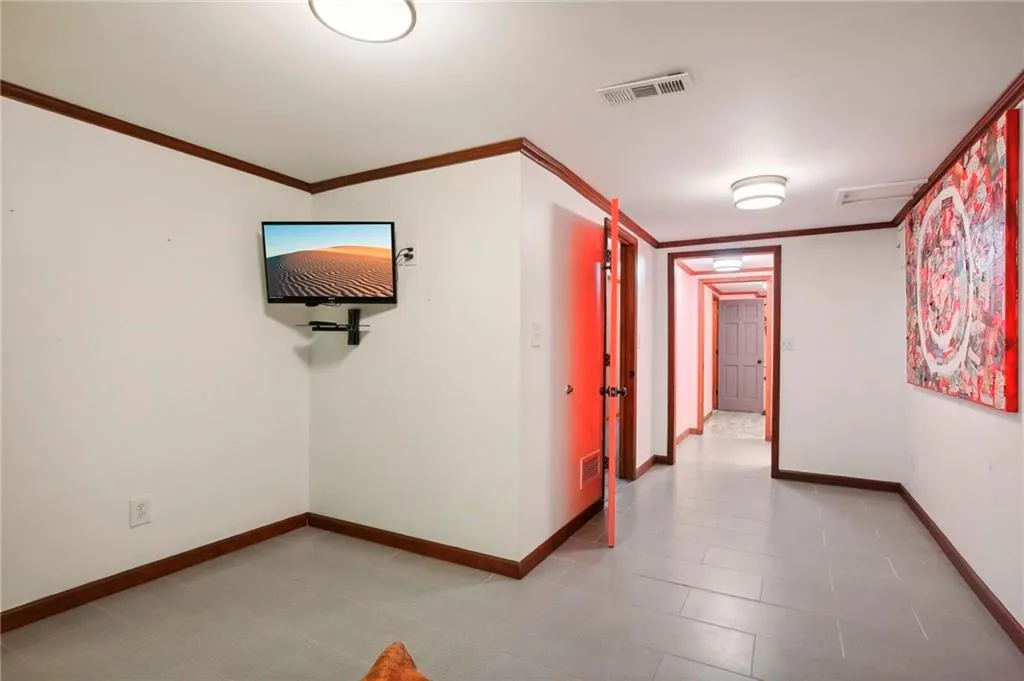 Hall with tile floors and crown molding