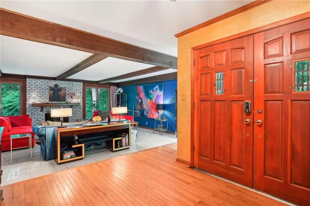Tiled foyer entrance featuring beamed ceiling