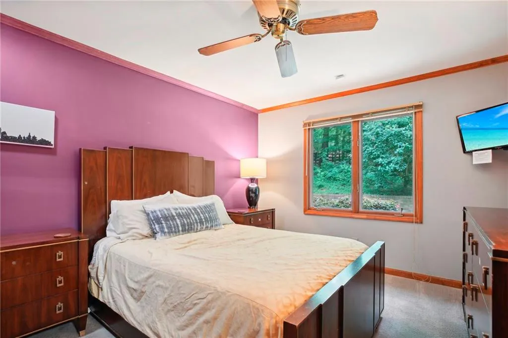 Bedroom with ceiling fan and carpet floors