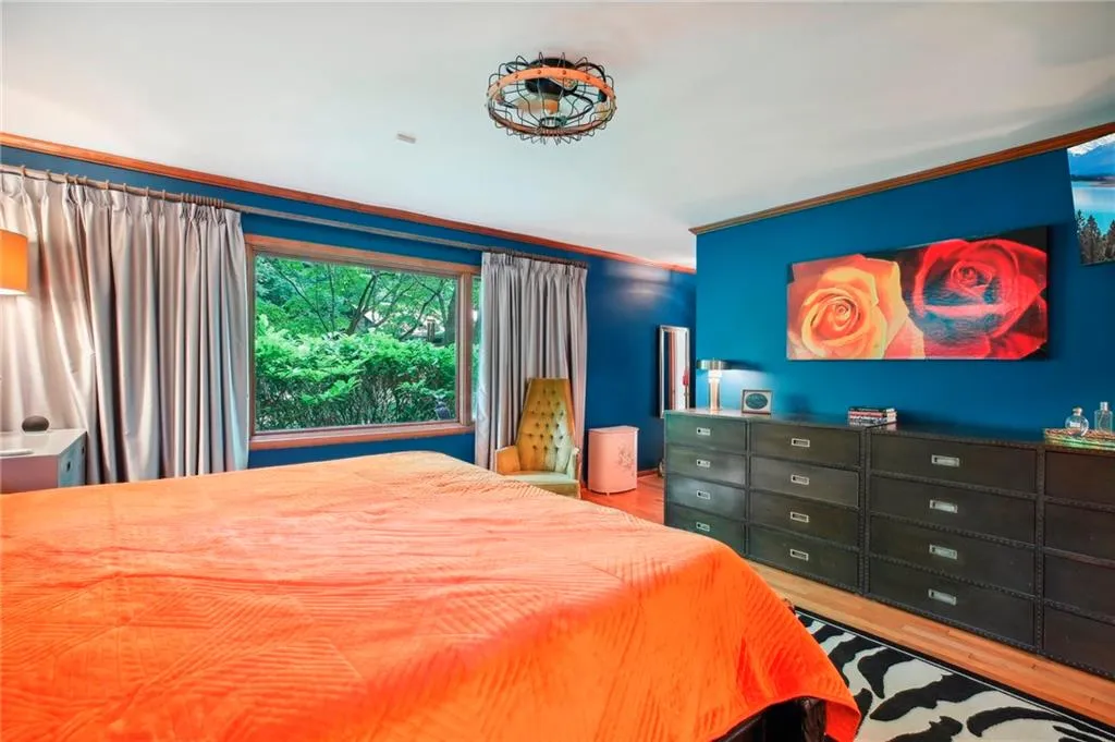 Bedroom featuring wood-type flooring and ornamental molding