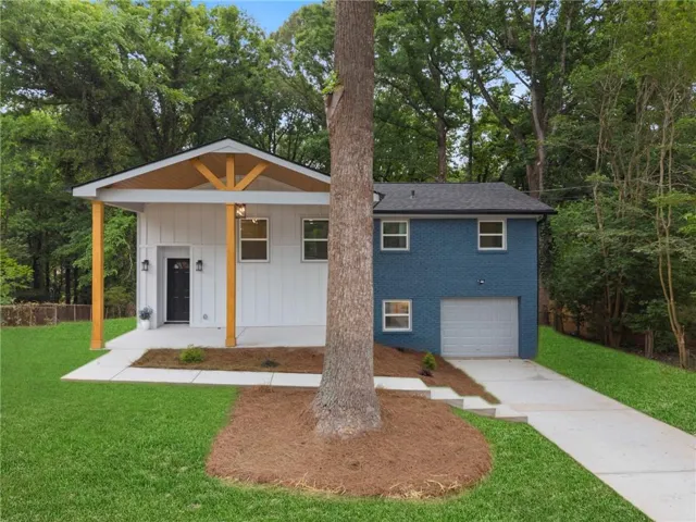 Modern dual-structure design featuring a contemporary white cottage with distinctive geometric roofline and golden accent trim, paired with a blue two-story residence with attached garage