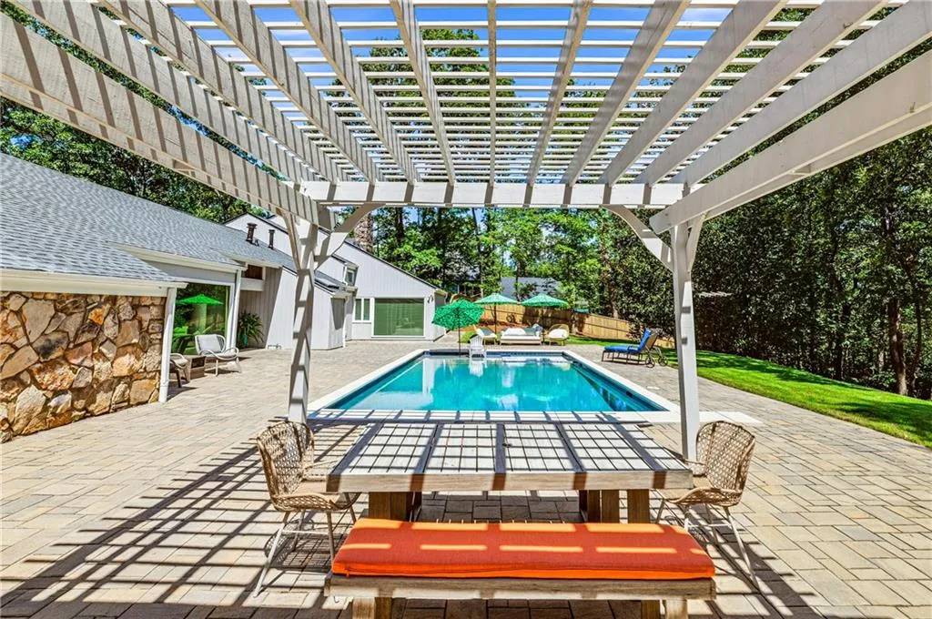 To left of pergola hidden among the siding of the home, two changing rooms and a full bathroom!