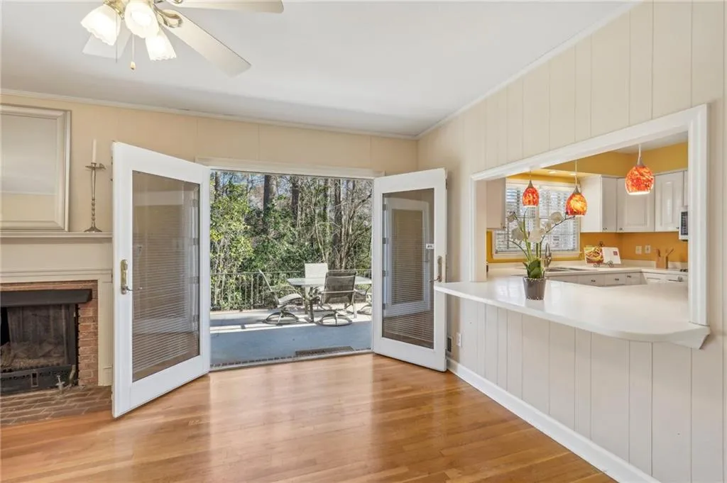 Family room with fireplace opens to kitchen and patio and includes hardwood floors.