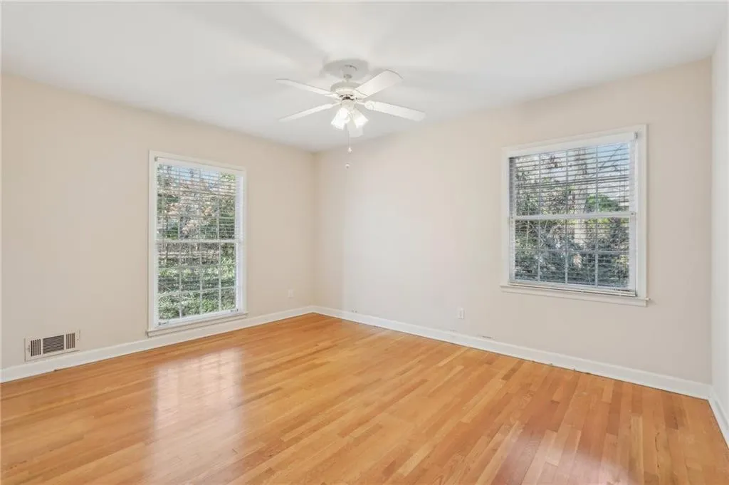 Bedroom3 with hardwood flooring, ceiling fan, and closet.
