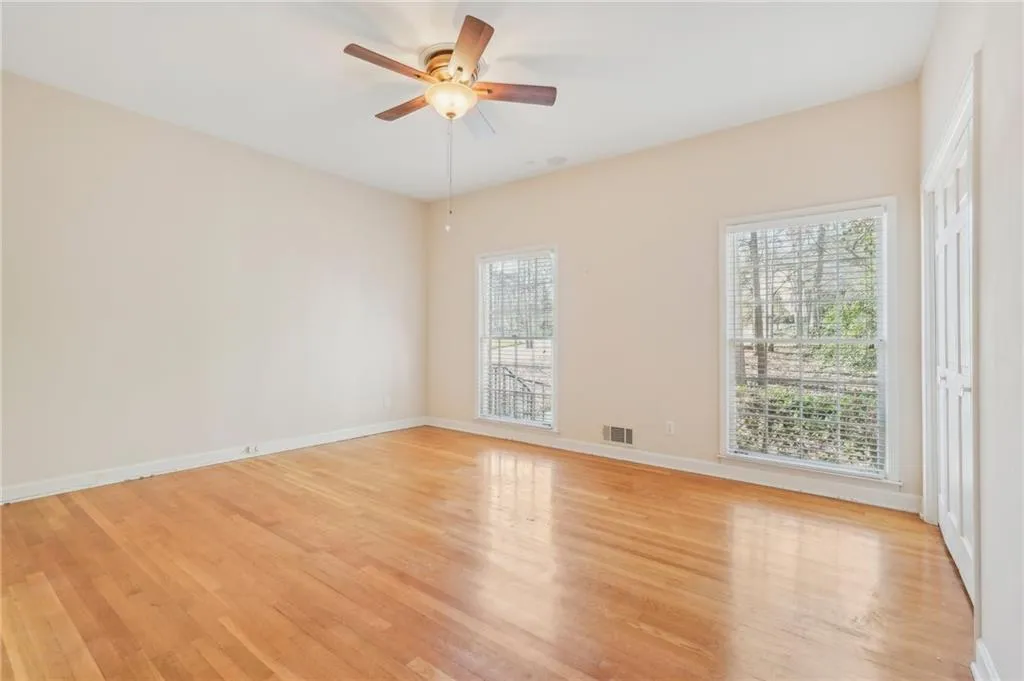 Bedroom 2 w/Hardwood floors, ceiling fan and closet.