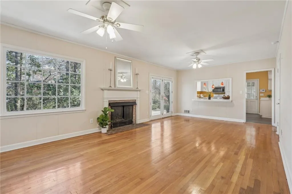Family room opens to kitchen and patio and includes hardwood floors, ceiling fans, crown moulding,and ceiling fans.