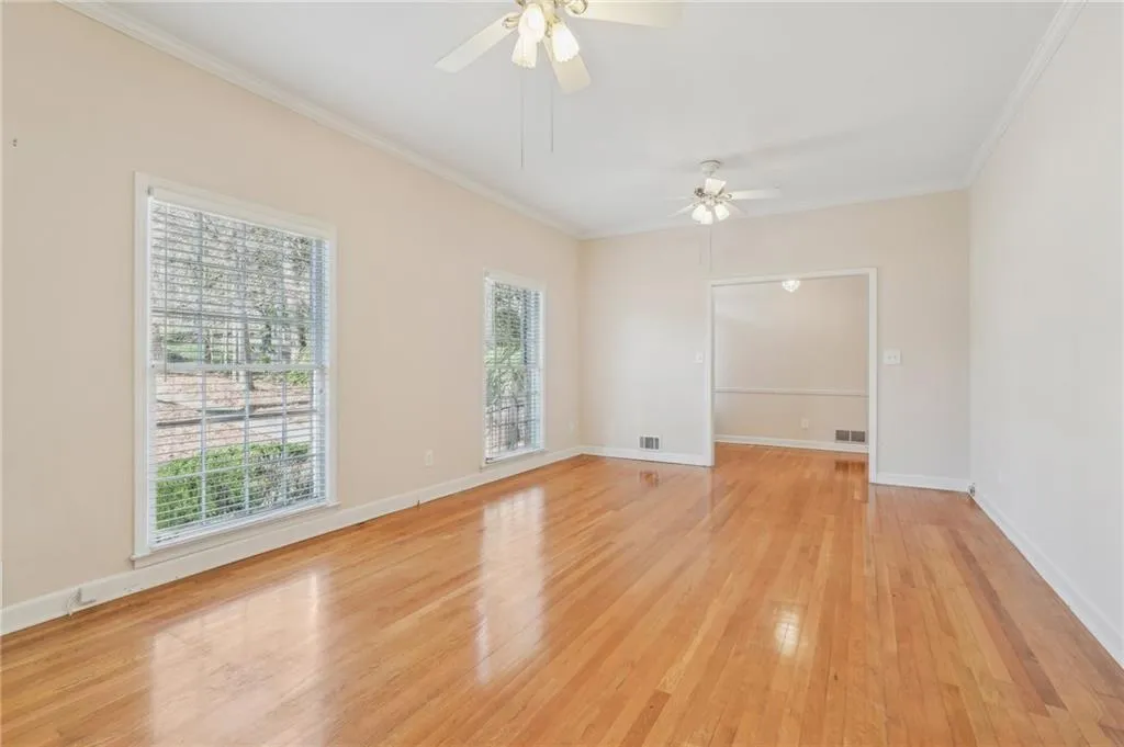 Living area w/hardwood flooring, molding, a wealth of natural light, ceiling fans