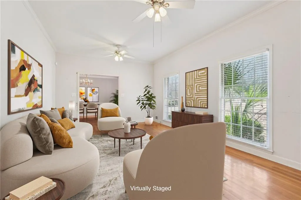 Living room w/hardwood flooring, ornamental molding, a wealth of natural light, and ceiling fans VIRTUALLY STAGED