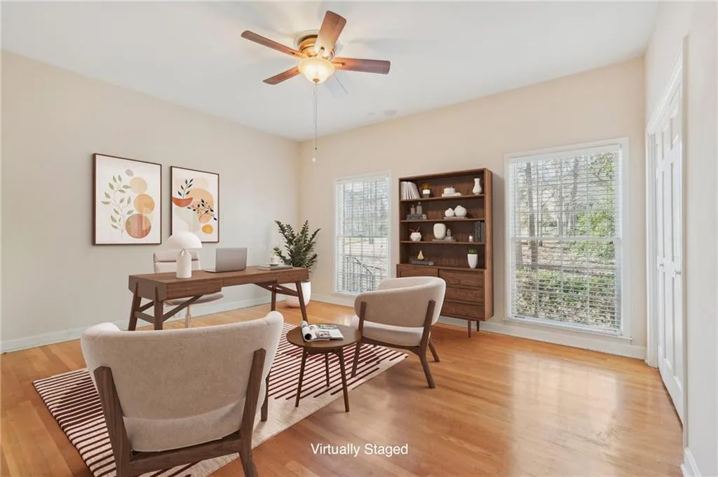 Bedroom 2 VIRTUALLY STAGED as an office - Office with light wood-style floors, a healthy amount of sunlight, ceiling fan, and baseboards