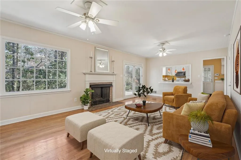Family room hardwood flooring, fireplace, ceiling fans opens to kitchen and patio. VIRTUALLY STAGED