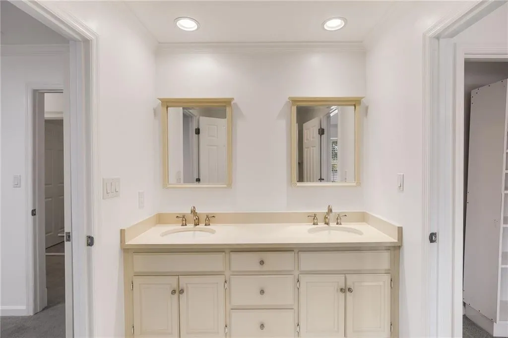 Full bath featuring ornamental molding, double vanity, and recessed lighting