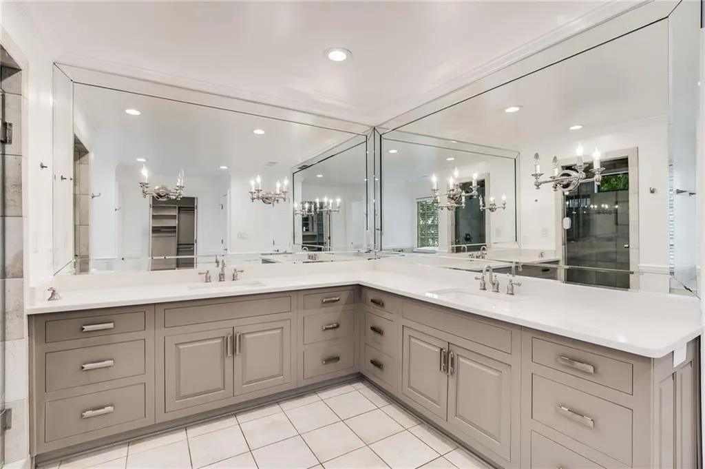 Full bath with a chandelier, double vanity, light tile patterned flooring, and recessed lighting
