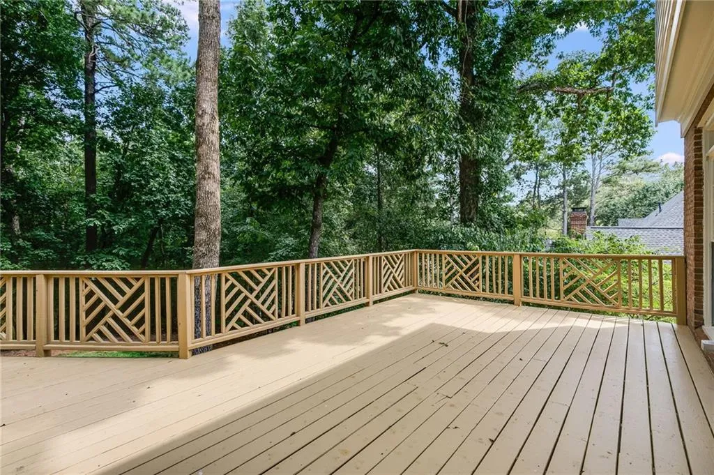 Wooden deck with view of scattered trees