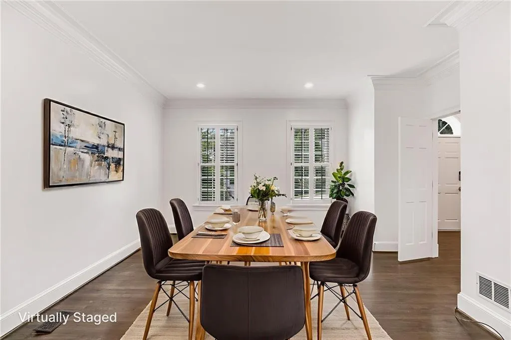 Dining room featuring ornamental molding, dark wood finished floors, and recessed lighting
