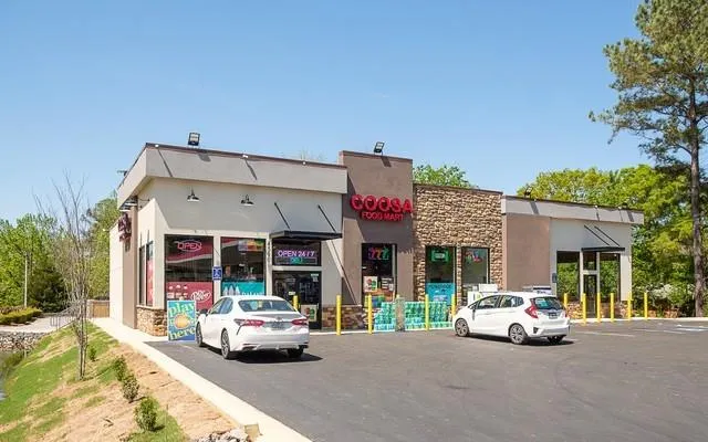 View of commercial property with uncovered parking
