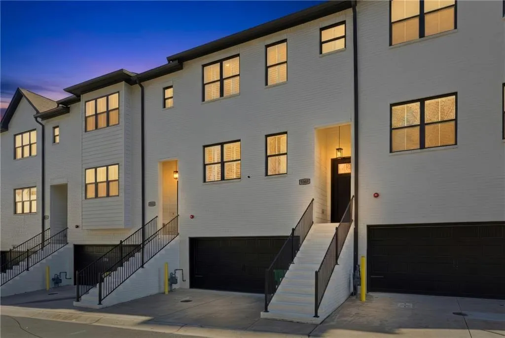 View of front of house with stairway, a garage, and driveway