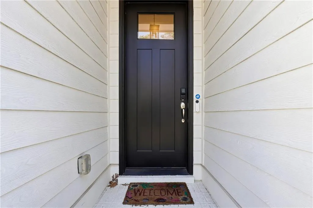 Doorway to property featuring a garage
