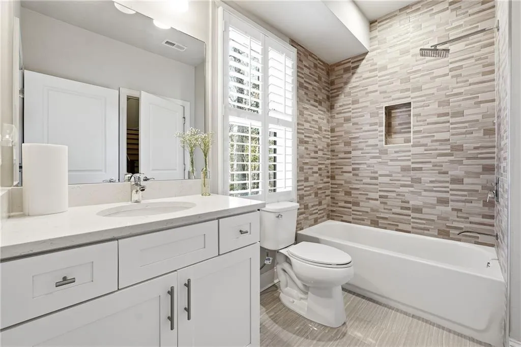 Bathroom with vanity and shower / bath combination