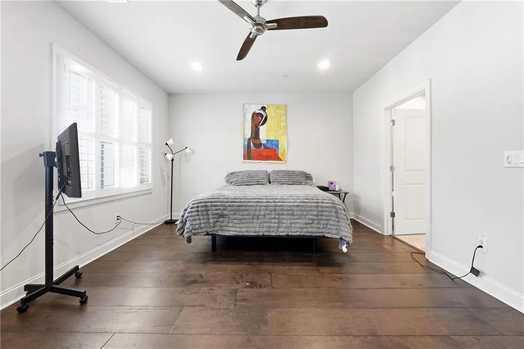Bedroom featuring dark wood-style flooring, ceiling fan, and recessed lighting