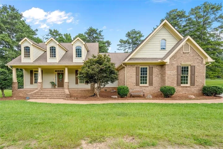 Brick and siding exterior w/ multiple dormers covered front porch