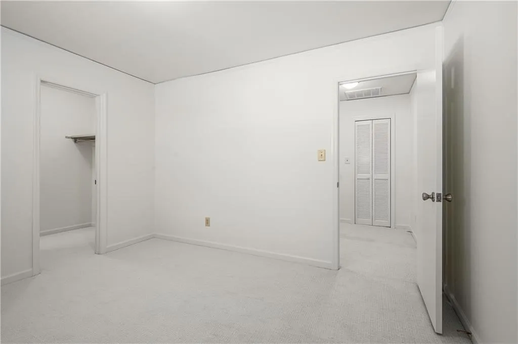 25 Forrest Place~ Alternate view of  Secondary Bedroom #1. Both upstairs bedrooms offer perfect guest rooms, home offices, exercise rooms, art spaces, storage- you name it. Or, close the doors and simply live on the first floor. You choose!