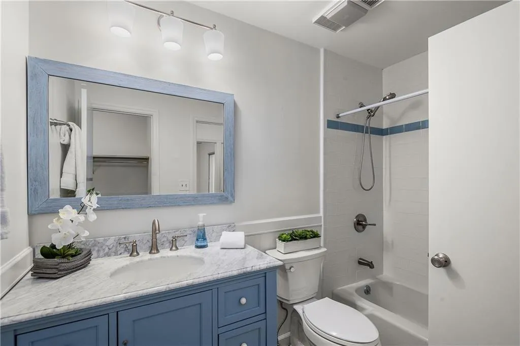25 Forrest Place~ Renovated Jack and Jill bathroom features shaker style cabinetry, stylish tile on the floor, and new plumbing fixtures.