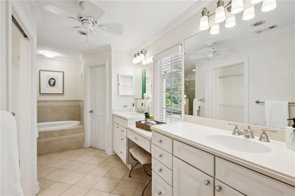 Full bathroom featuring ornamental molding, light tile patterned floors, a closet, and vanity