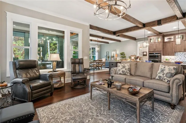 Open-concept living area with dark wood-finish flooring