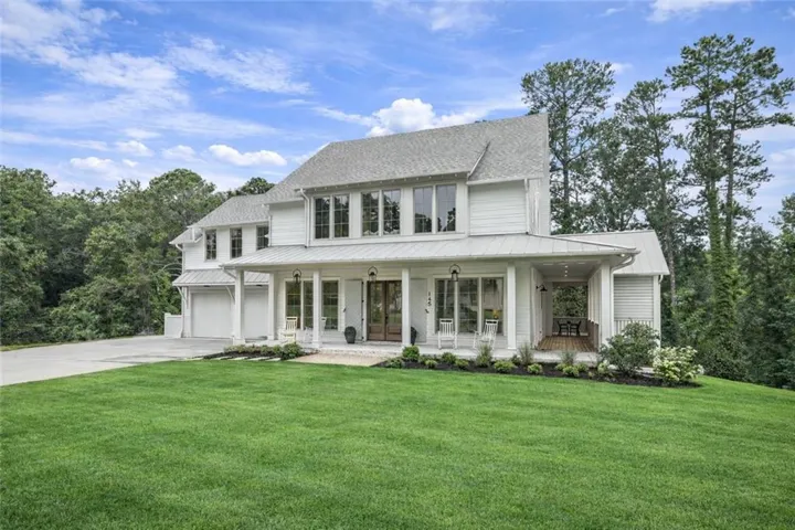 Traditional, coastal - inspired style home featuring a beautiful covered wrap-around porch