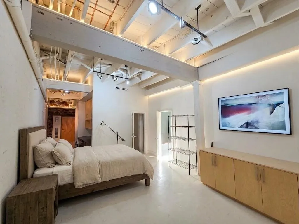 Exposed ceiling beams, track lighting, virtual bed, TV and LED cove lighting