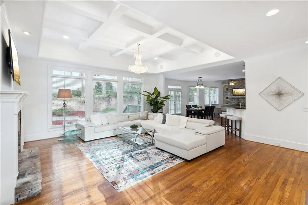 coffered ceiling, a stacked stone fireplace,