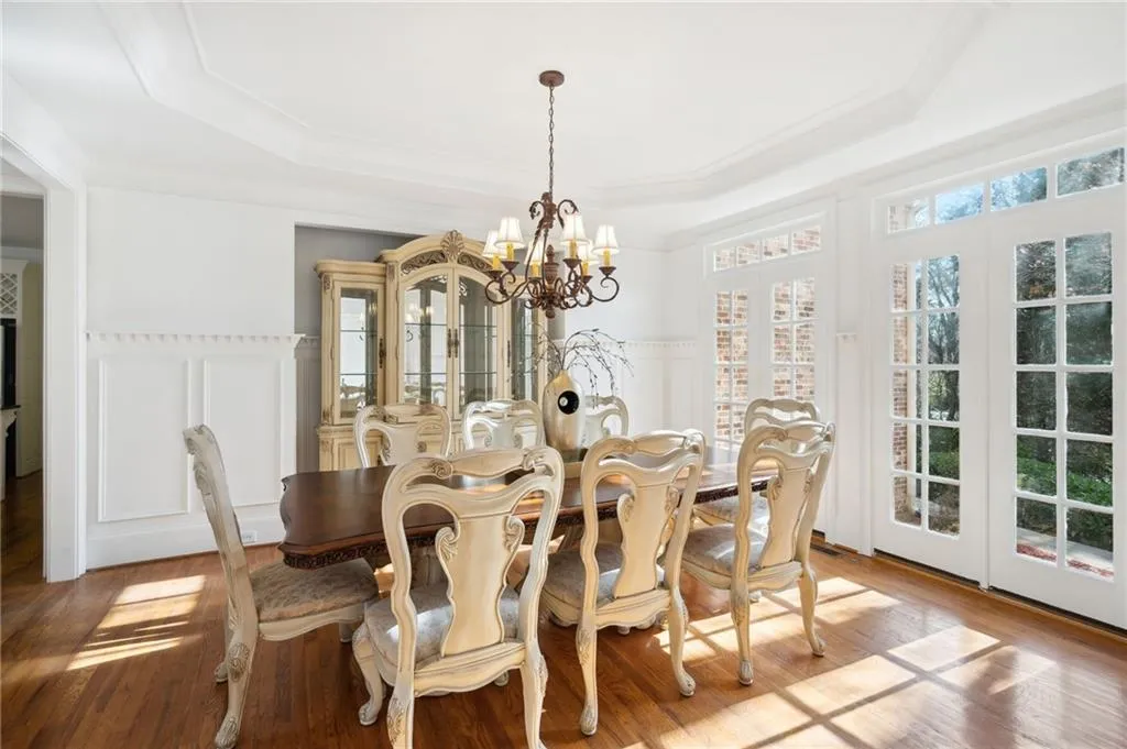 Formal dining featuring a chandelier, a tray ceiling, and crown molding
