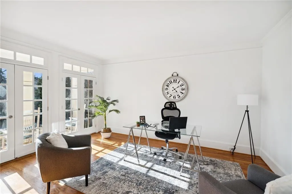 Office area featuring french doors, crown-molding, and light hardwood / wood-style floors