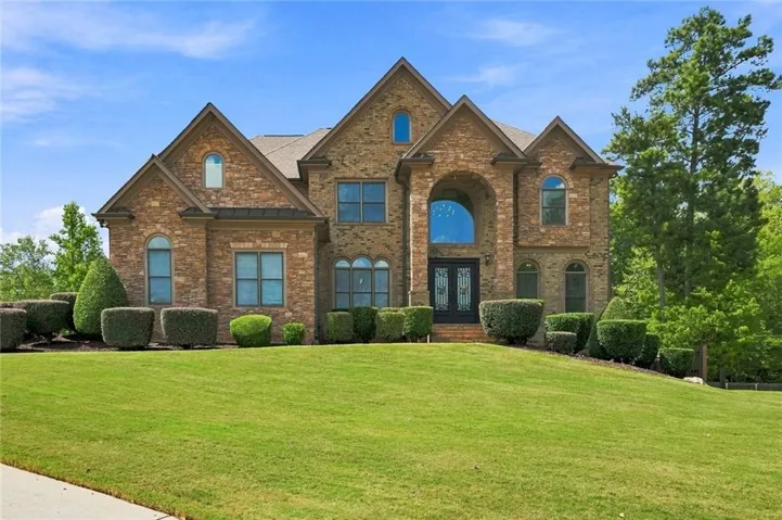 Stately stone and brick facade with multiple gables