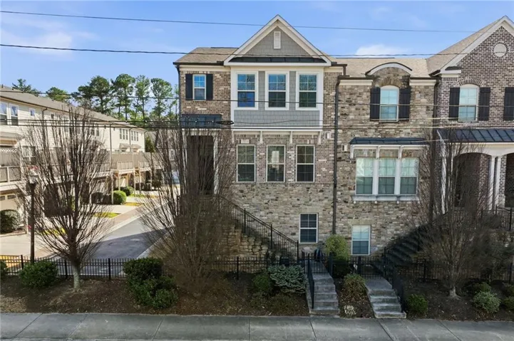 View of front of home featuring a fenced front yard and brick siding