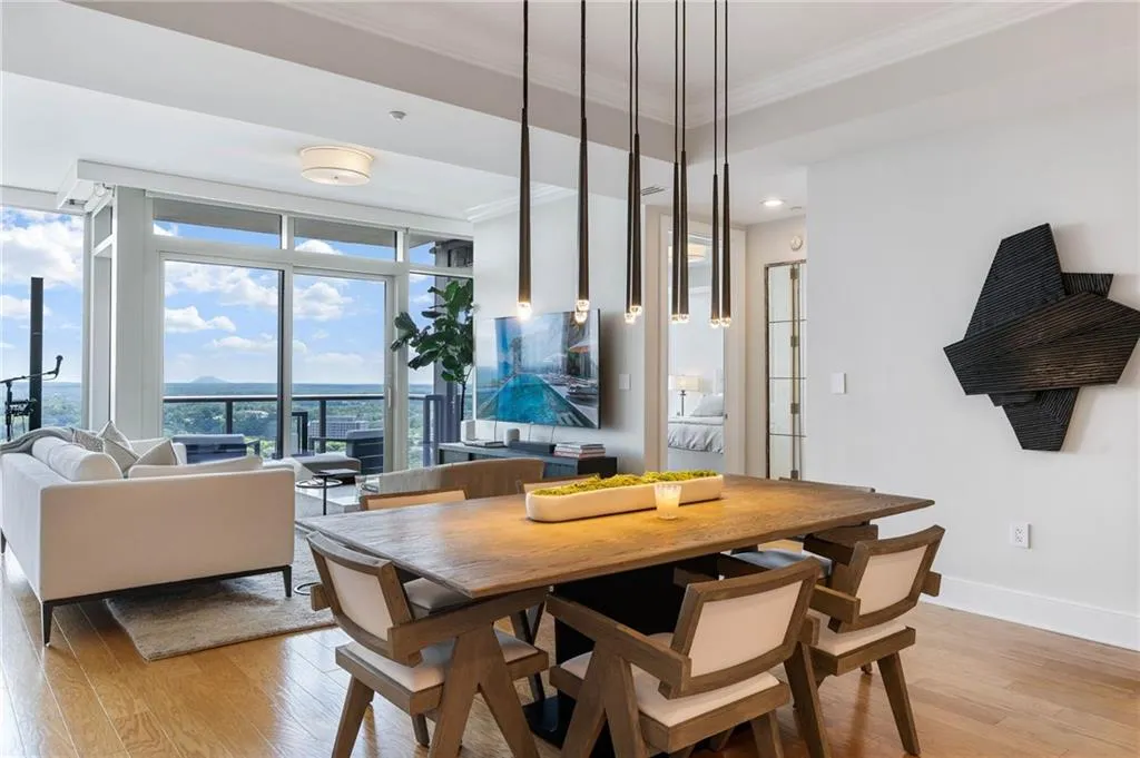 Dining area featuring light wood-style flooring, expansive windows, and ornamental molding