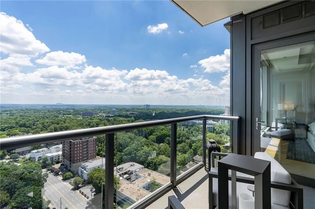 Balcony featuring a city view and view of scattered trees