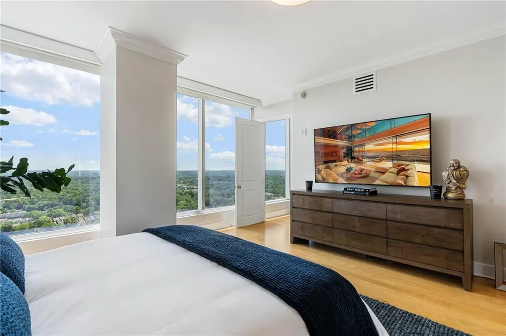 Bedroom featuring light wood-style flooring and crown molding