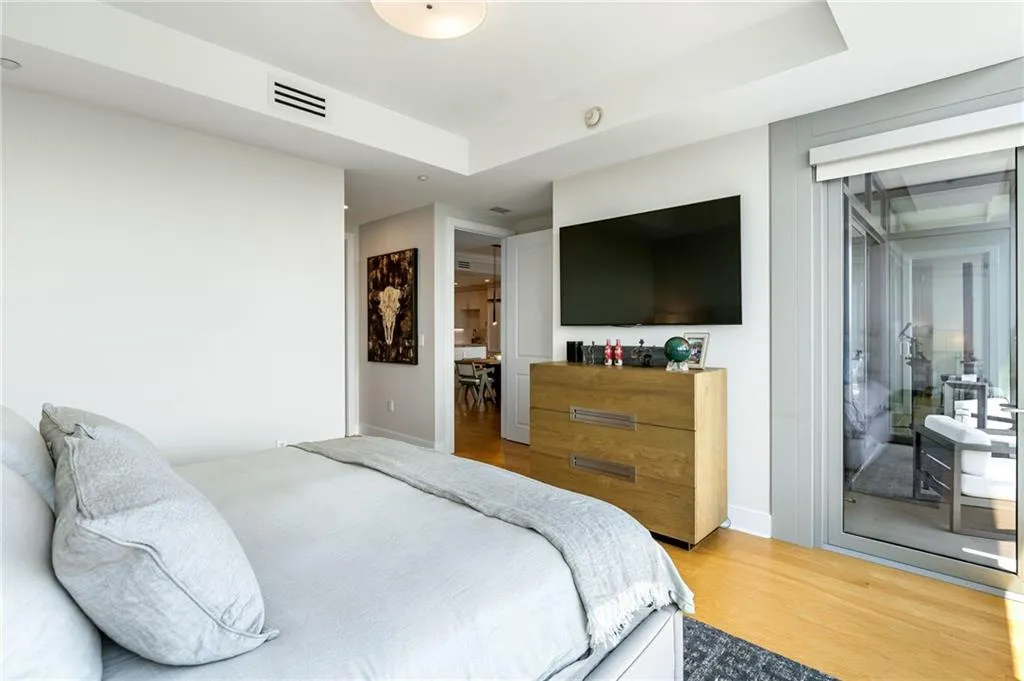 Bedroom with wood finished floors and access to exterior