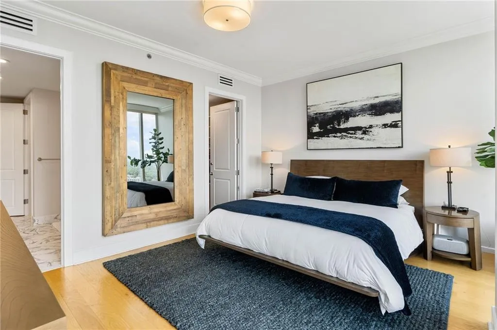 Bedroom featuring crown molding and light wood finished floors