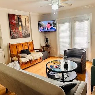 Living area with crown molding, wood finished floors, and ceiling fan