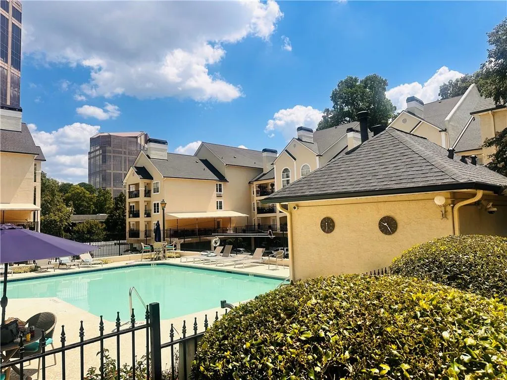 Community pool featuring a patio and a residential view