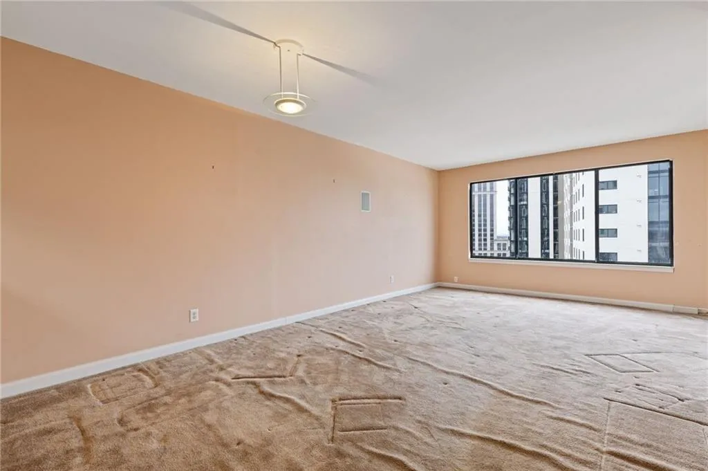 Unfurnished room with baseboards and carpet floors