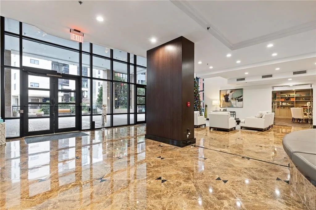 Building lobby featuring a wall of windows and recessed lighting
