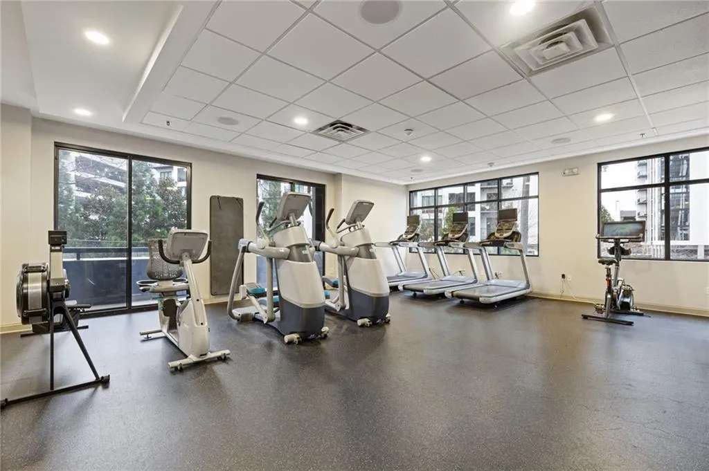 Exercise room featuring a drop ceiling and recessed lighting