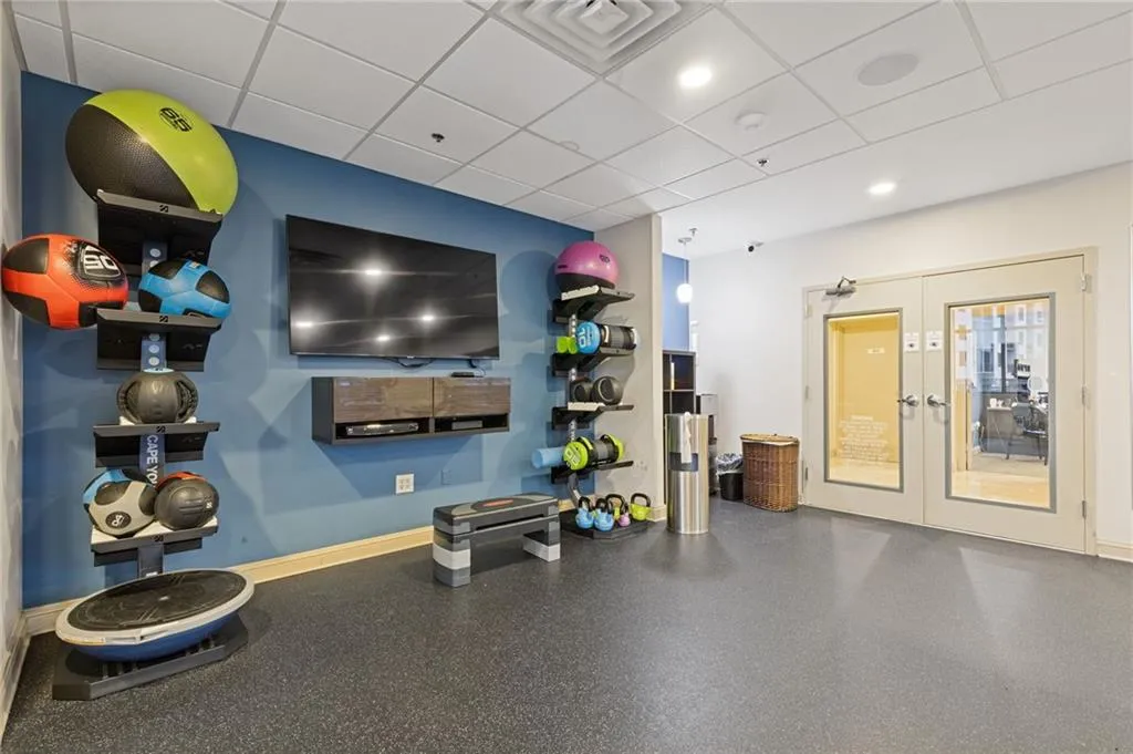 Exercise area with a paneled ceiling and french doors