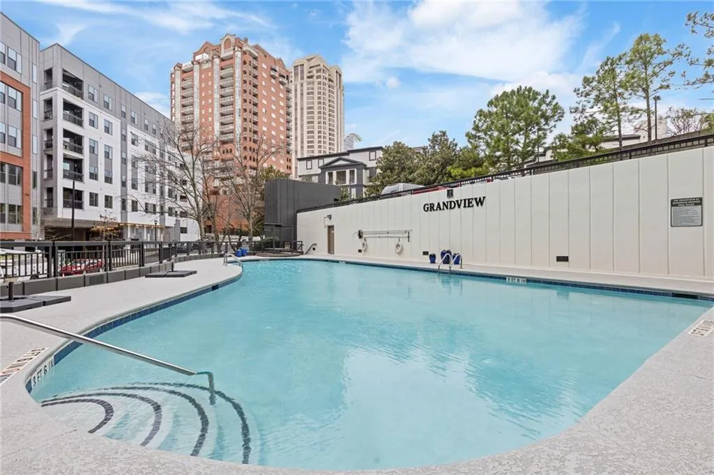 Community pool featuring a patio area and a city view