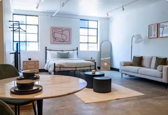 High ceilings and exposed track lighting create an expansive atmosphere