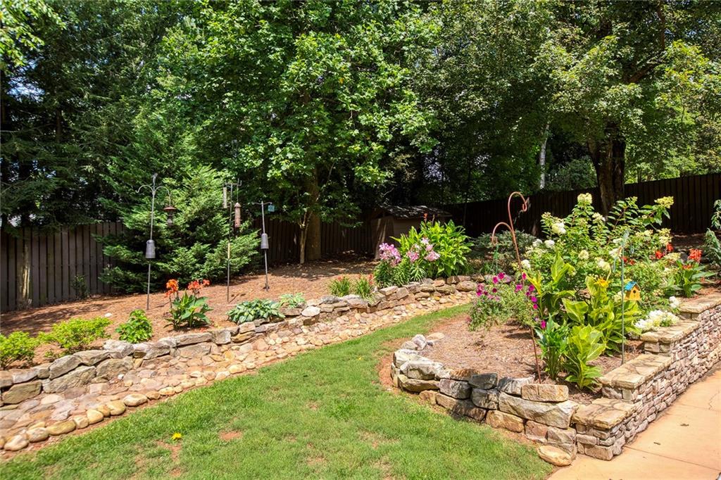 Handsome stonework throughout the landscape.   Plenty of sun and room for perennial and vegetable gardeners!