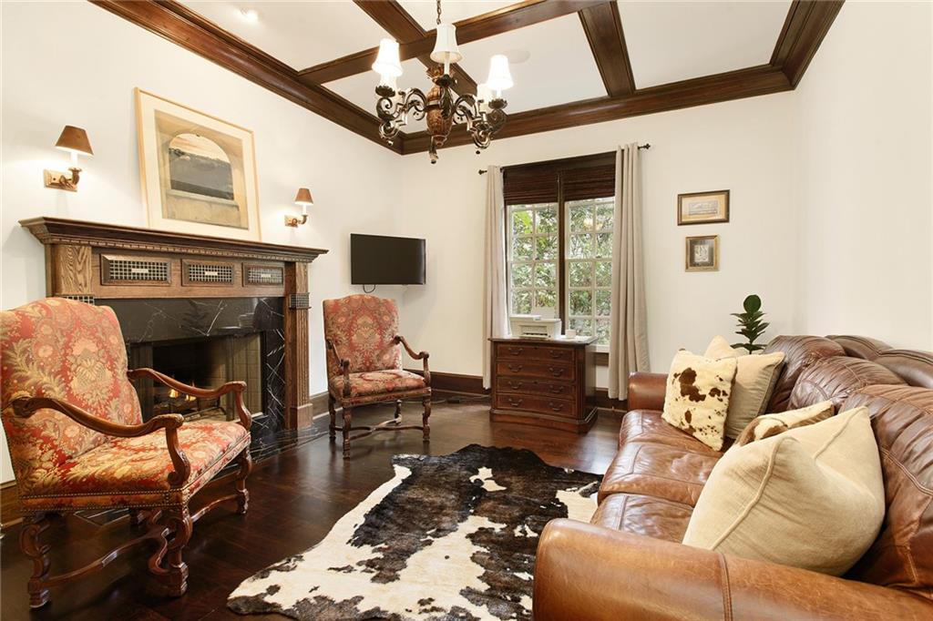 This handsome space is also on the main floor and offers a wood burning gas fireplace.  It is adjacent to the morning bar near the Primary bedroom suite. A perfect office space away from the family living area and double doors to close for privacy.